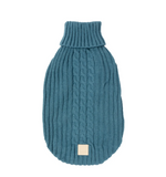 A french blue cable-knit pet sweater with a ribbed turtleneck, shown flat against a solid white background. A small beige square label is stitched near the bottom hem.